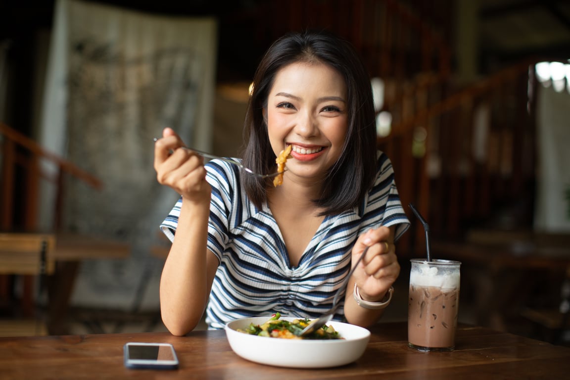 Young Asia Woman Eating Spaghetti at Restaurant